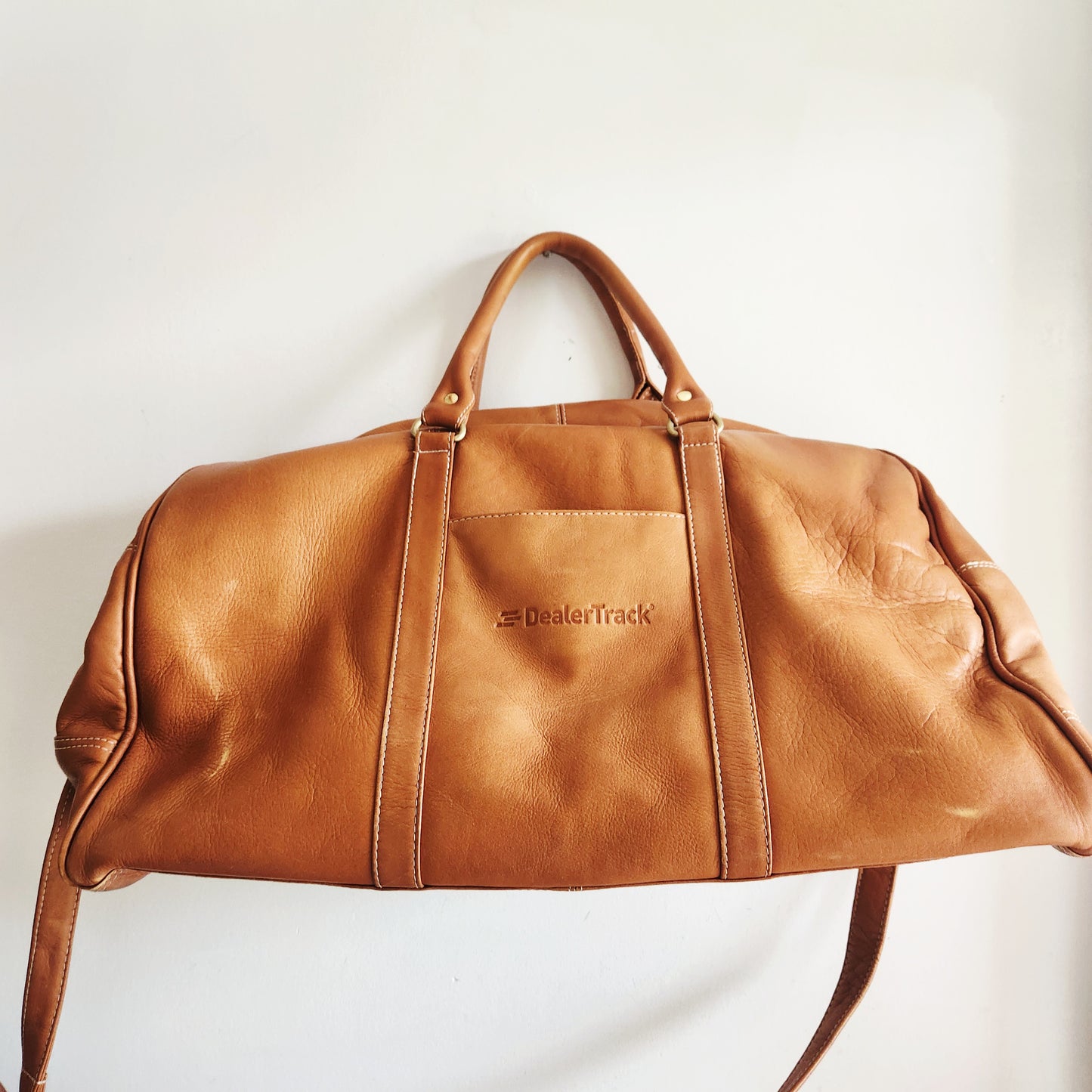 Latico Leathers Weekend Bag with Pockets says "Dealertrak"on one side